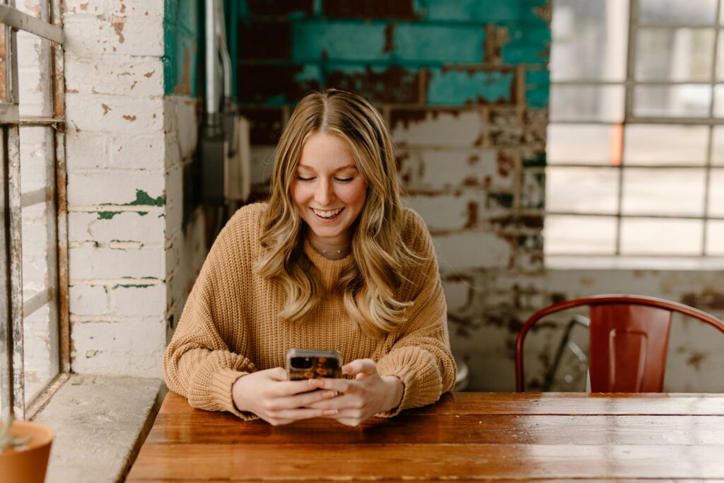 A woman scrolling social media on her phone
