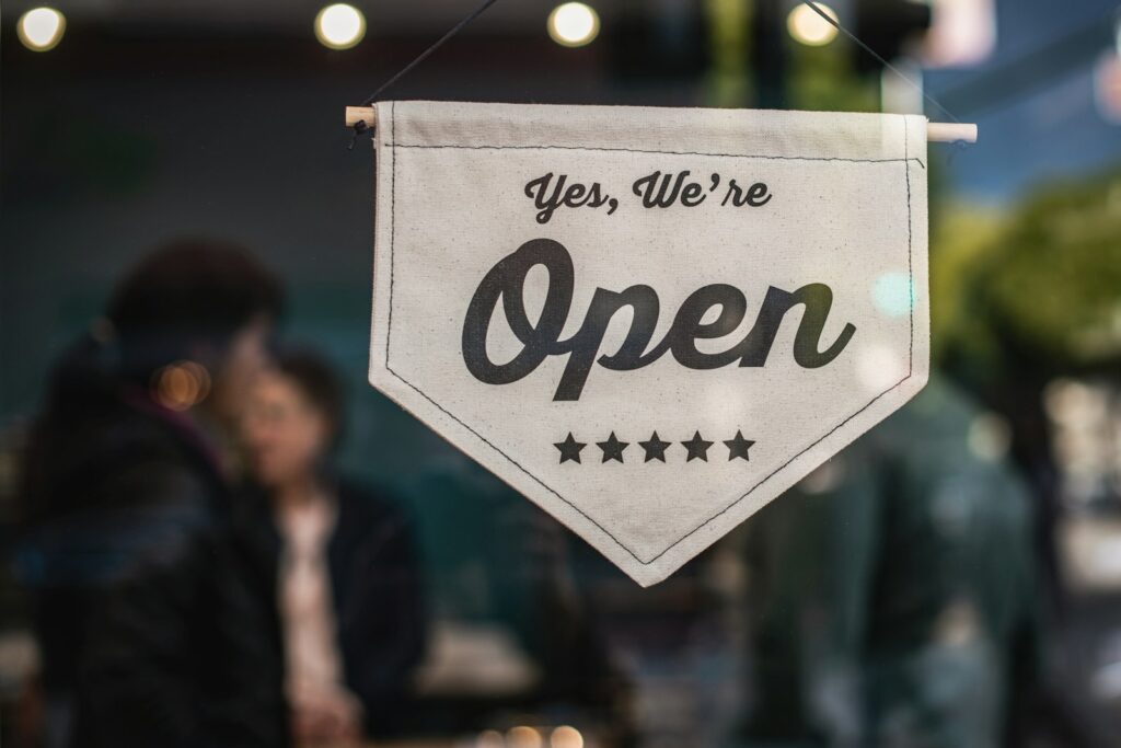 A "Yes, we're open" sign at a small business