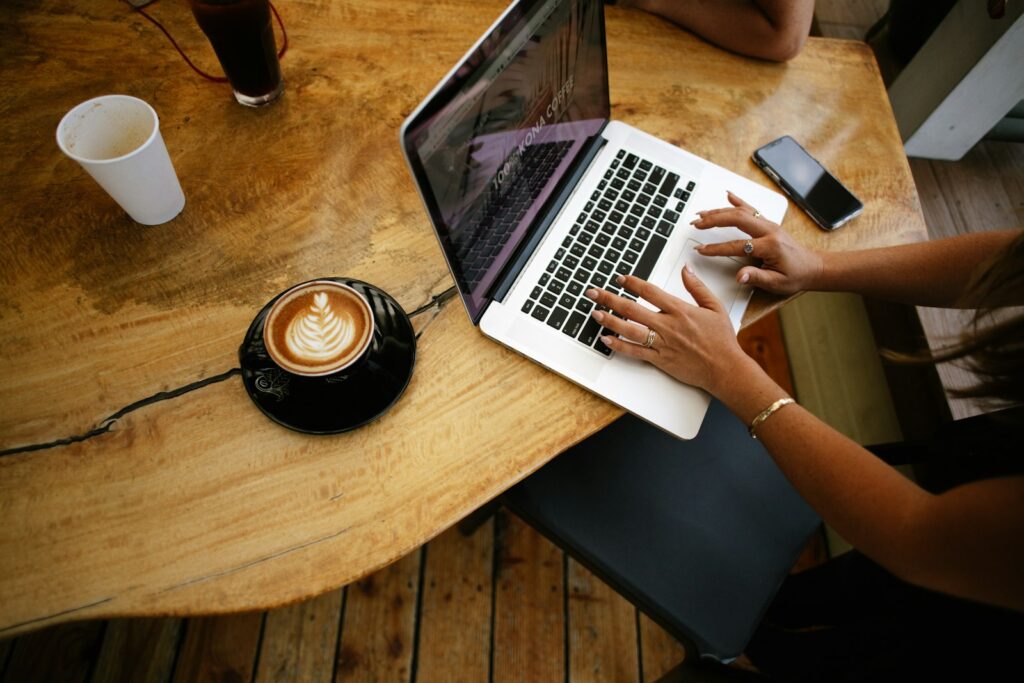 Working through email on a laptop at a café table