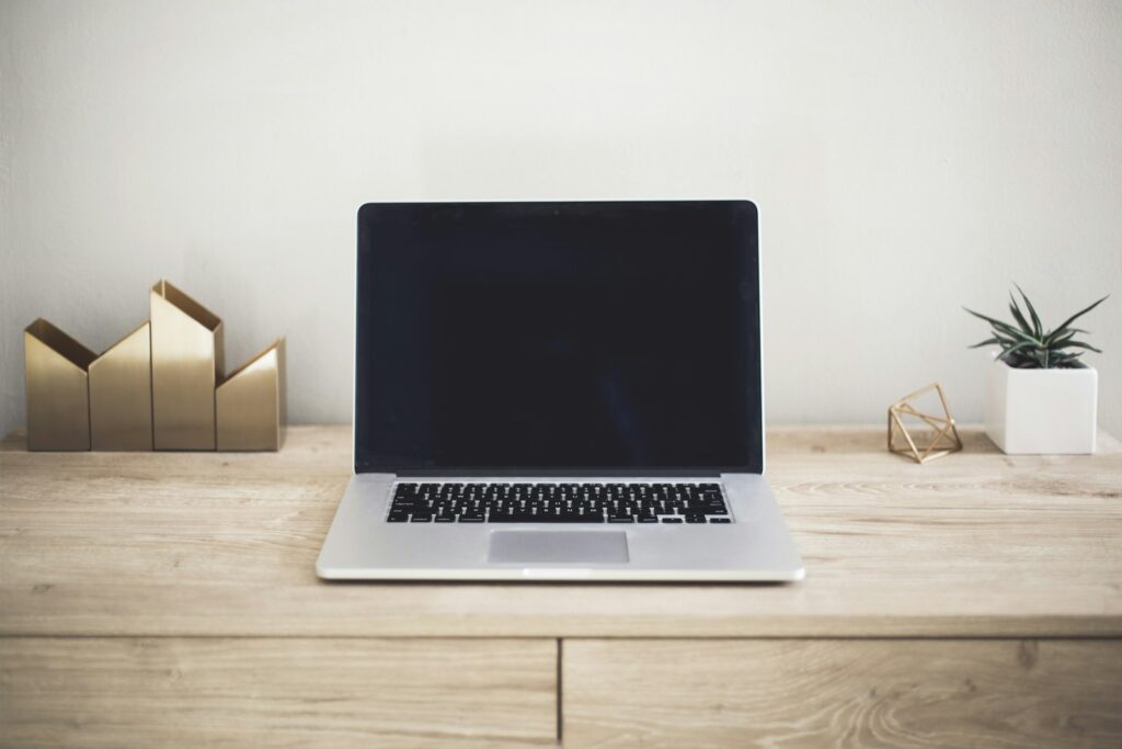 A clean, uncluttered desk with a laptop